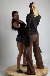 OXANA AND XENIA STANDING POSE WITH GUNS 2